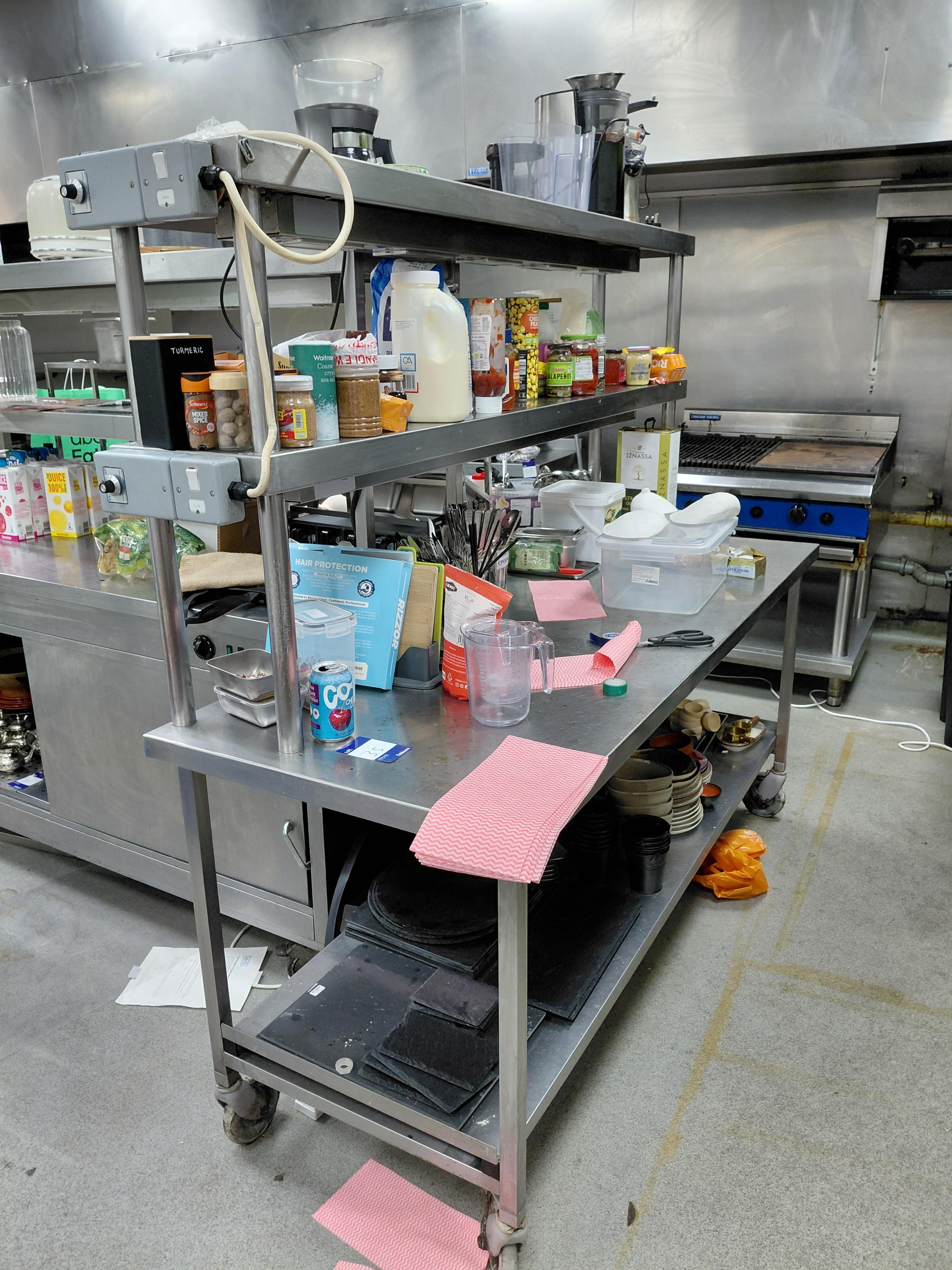 Stainless steel table with heated gantry over with contents - photo 1