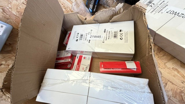 Open box containing electrical switches, modules, accessories, and packaged electrical components, W - photo 1