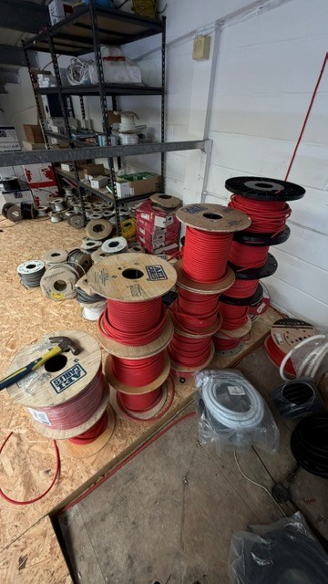 Multiple large reels of red cable. This lots forms part of composite lot 68. At the end of the timed - photo 1