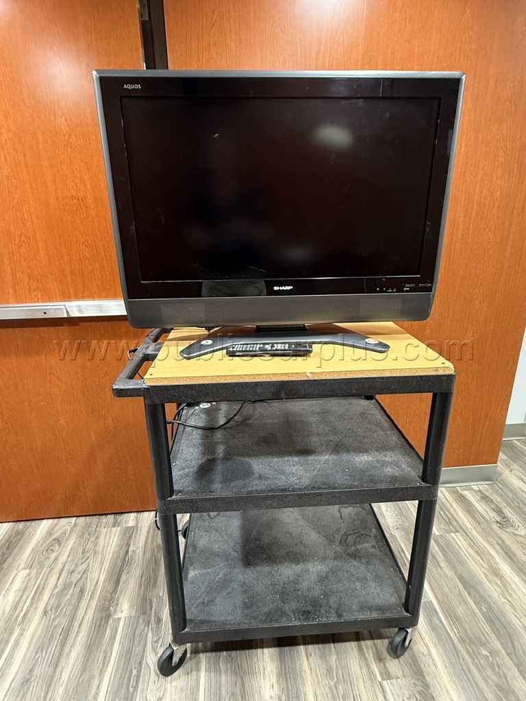 Sharp TV mounted on black cart — photo 1