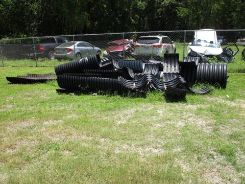 LARGE PILE OF USED CORRUGATED PLASTIC PIPES
