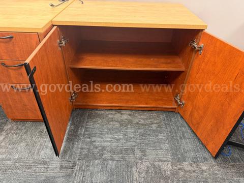 Cherry laminate two-door office storage cabinet with a single interior shelf
