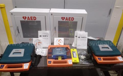 Lot of Cardiac Science PowerHeart AED G3 defibrillators and wall cabinets.