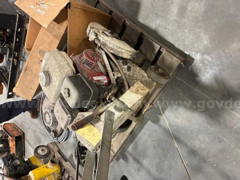 Pallet of trailer hitches, road saw, push mower, mack air horn, winch cable