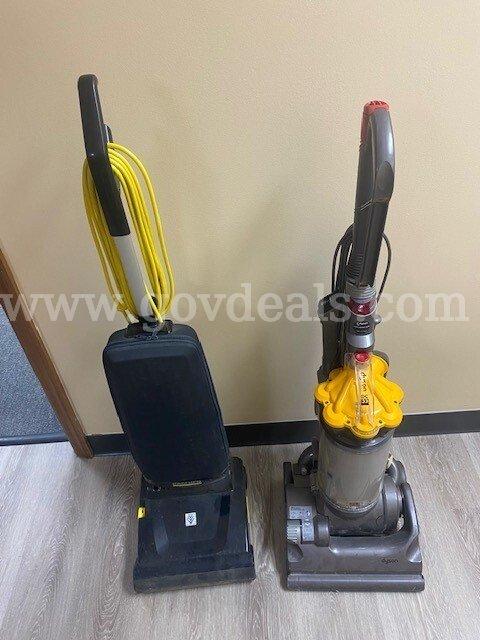 Two old broken vacuums, one Dyson and one Karcher.