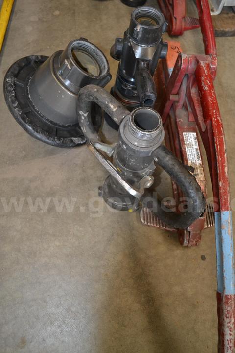 Lot to include Lever style hose clamp, 1.5" Fog nozzle, 2.5" Deck gun fog nozzle, and a 2.5" nozzle valve