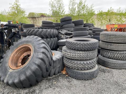 Pile of assorted tires and rims for trucks and equipment