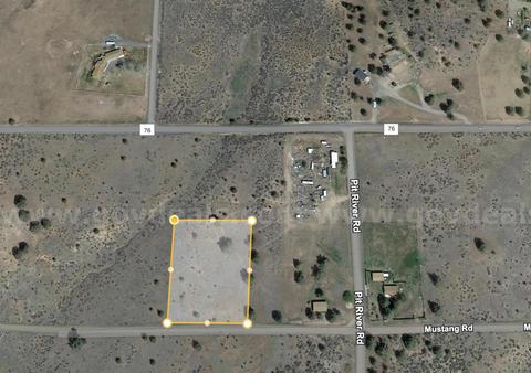 Large flat lot near house in Alturas perfect for development.