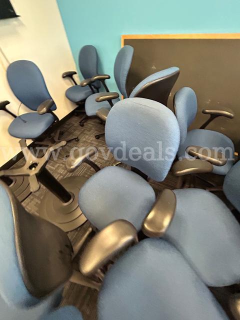 One lot of (24) blue cloth chairs with wheels