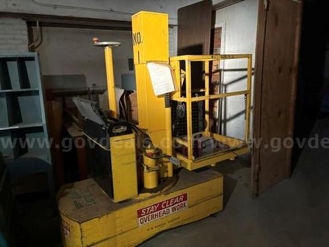 Vert-A-Lift yellow industrial stock picker or maintenance platform truck