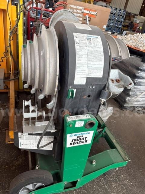 Greenlee 855 Smart Bender, an electric conduit pipe bender mounted on a green tr