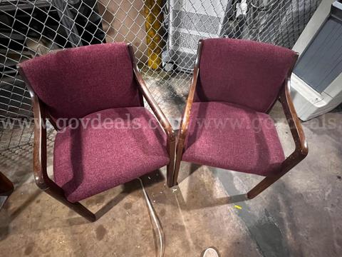 Lot of 2 Red cushioned chairs with wooden frame and arm rest