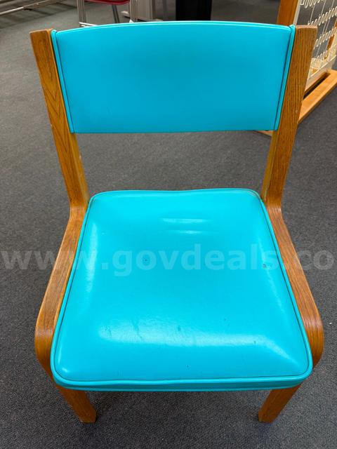 A Chair with wood frame and blue vinyl seat