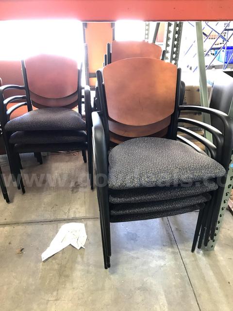 12 used cushioned and wood stackable chairs. (S2)