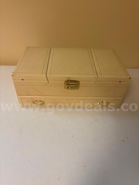 Lot of a jewelry box and its assorted jewelry contents.