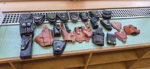 ASSORTMENT OF USED GUN AND CUFF HOLSTERS