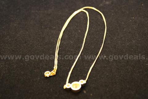 Gold colored necklace and pendant