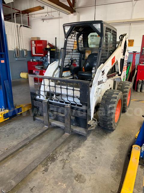 2002 Bobcat skid steer with attachments.