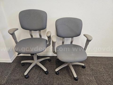Two gray rolling desk chairs (25.5"x36-41"x19" each)