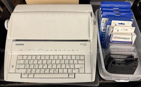 Brother ML 100 Standard typewriter with lid, various ribbons and corrective film ribbons, and cushioned pad (works!)