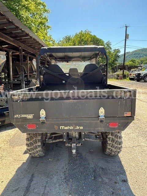 Mahindra Retriever 1000 UTV 4X4 With dump bed. Runs and drives. Has a winch mounted on the front.