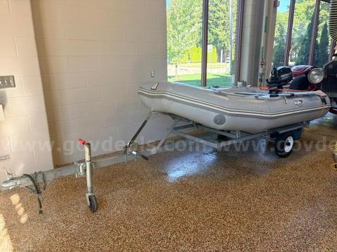 10 foot inflatable boat with 6hp outboard motor and trailer