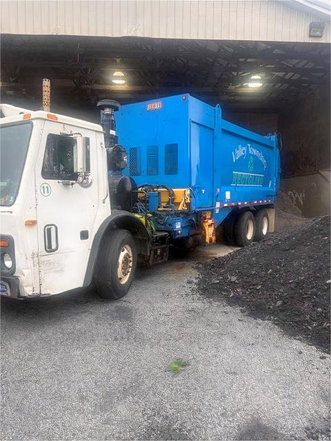 2010 Mack LEU Side Arm Recycling Truck with a Heil Body.