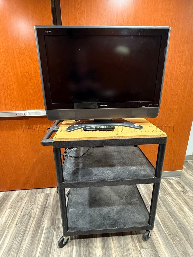 Sharp TV mounted on black cart — photo 1